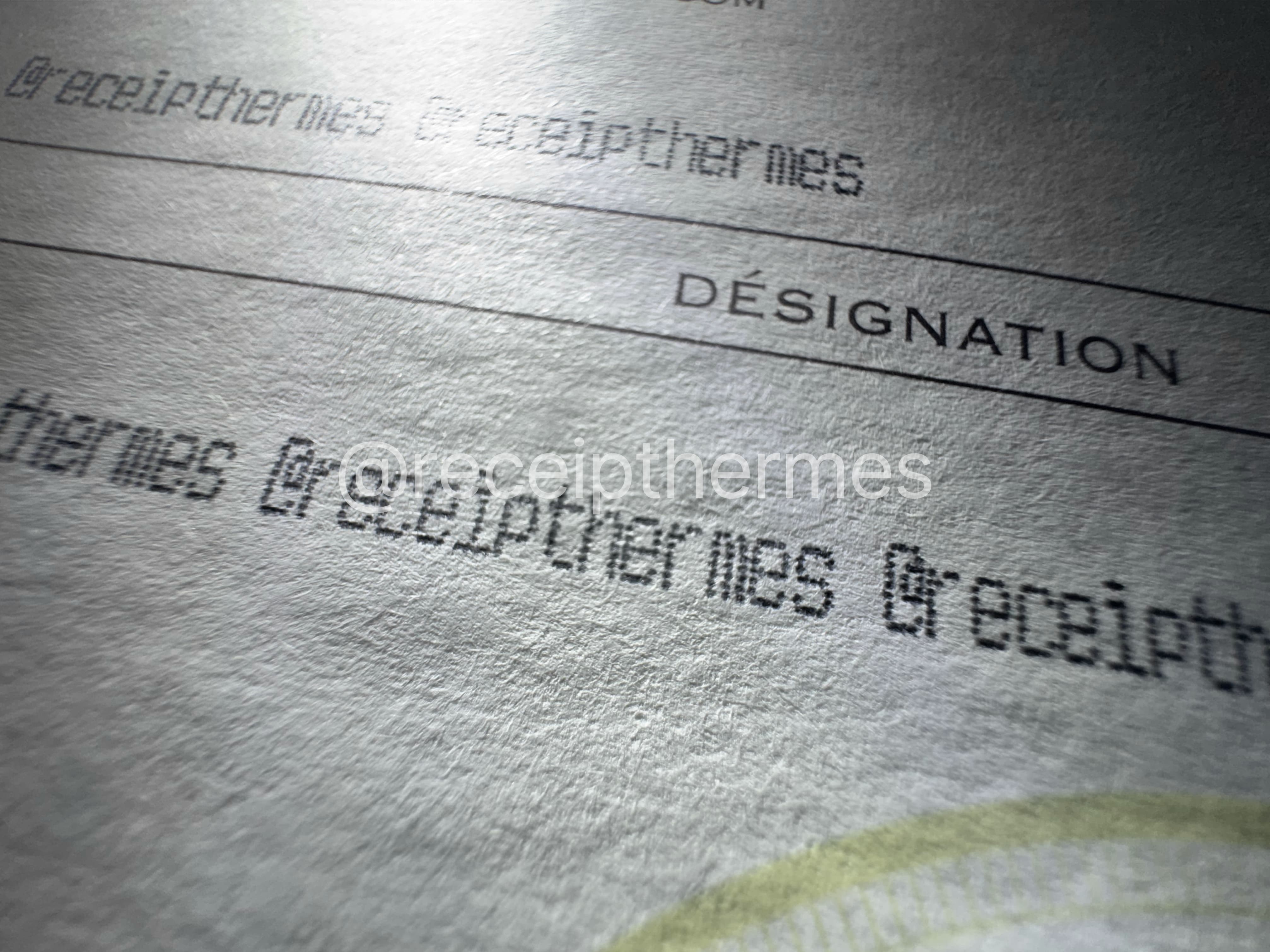 Replacement Hermes receipt extreme closeup — dotmatrix printing character formation and paper fiber interaction